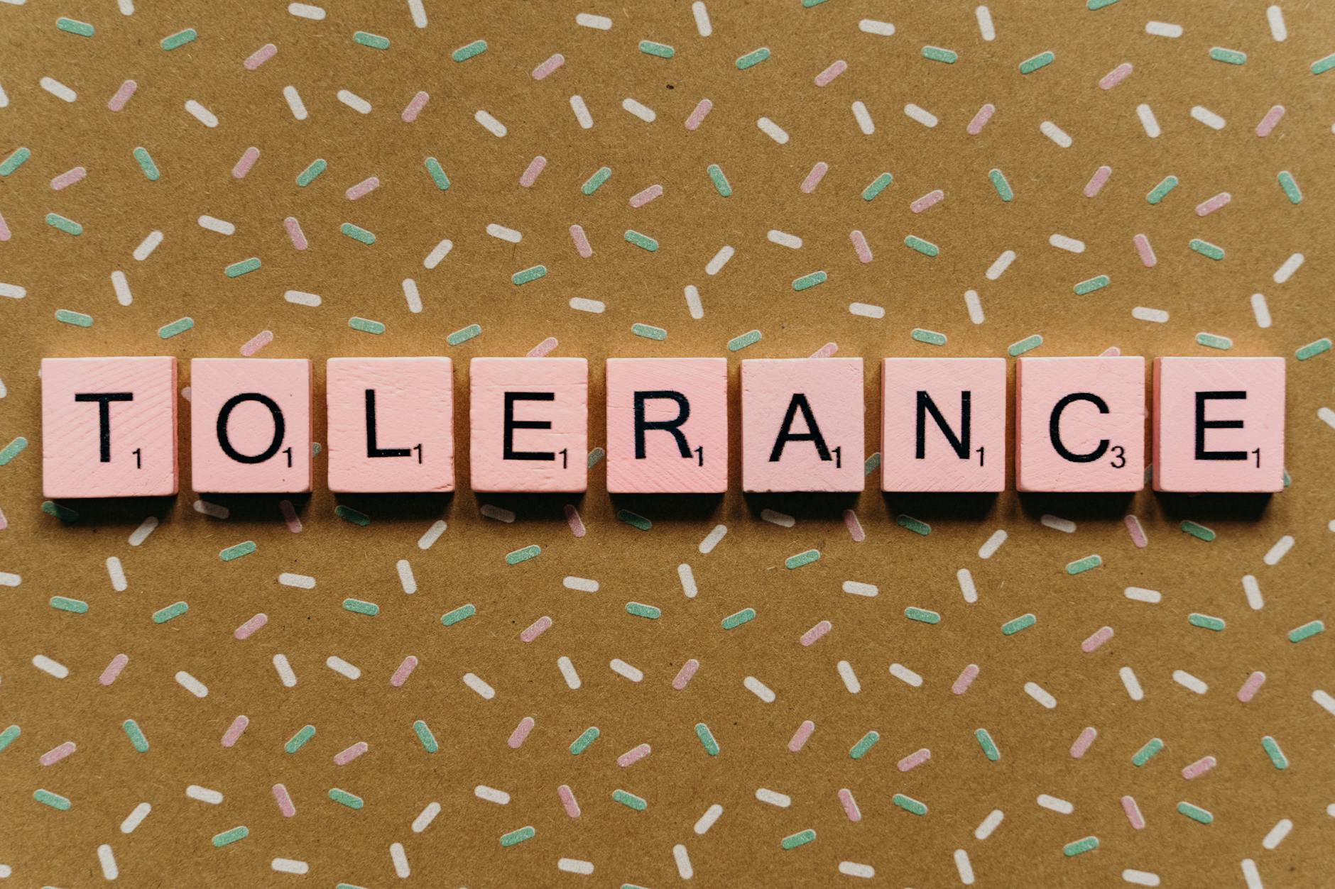 Word "Tolerance" with Scrabble chips The word "Tolerance" formed with Scrabble chips on a decorated background, highlighting the importance of inclusion and respect.